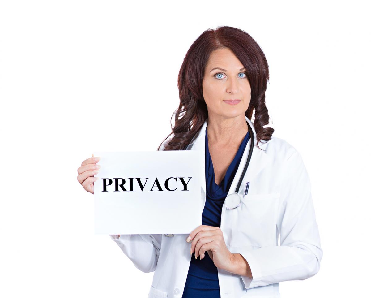 Woman Doctor holding a Privacy Sign